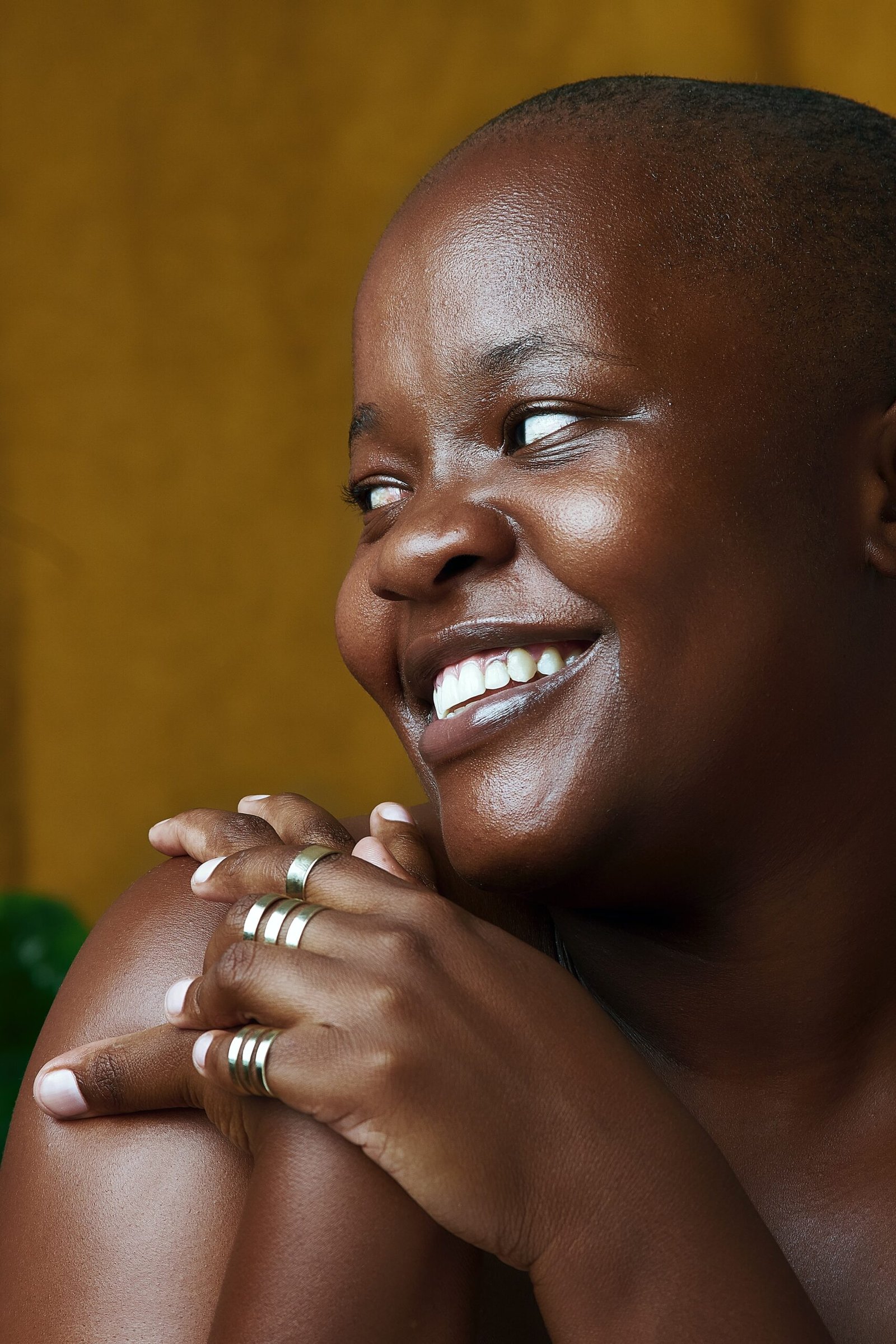 a smiling woman with her hands on her chest